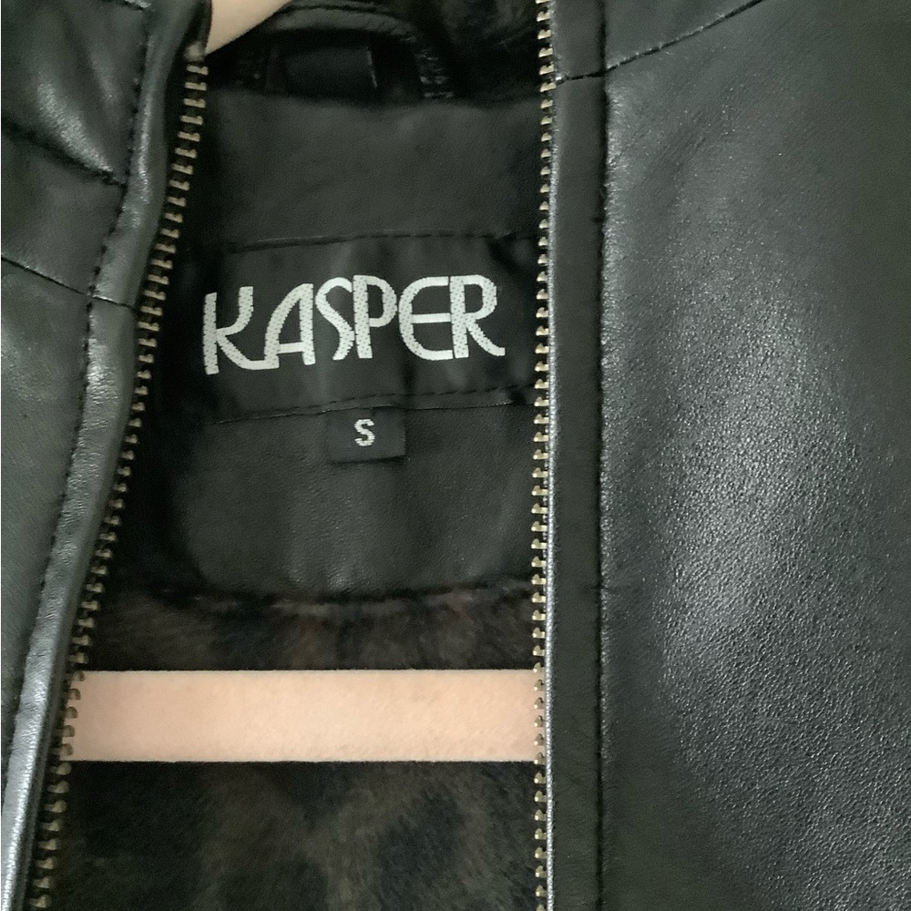 Women’s 3/4 black leather coat with zipper closing and hood.
